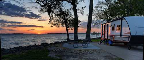 RV by the lake with a sunset