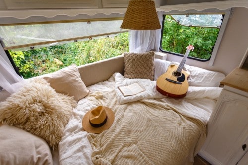 Interior of RV bed with decorative pillows