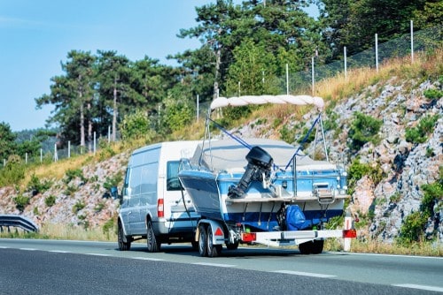 RV with a boat on the back driving down the highway