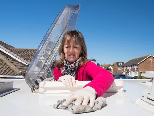 woman looking at the roof of an rv