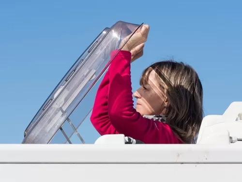 woman blocking uv rays from rv roof