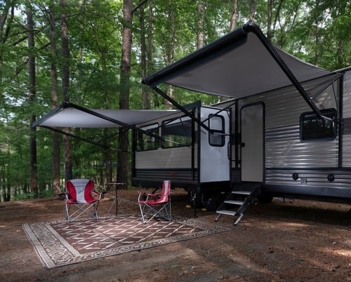 Example of an RV awning on a parked RV in the woods