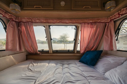 inside of a camper with a full mattress