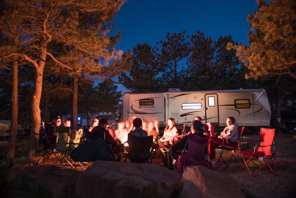people gathering around an RV reading campfire books